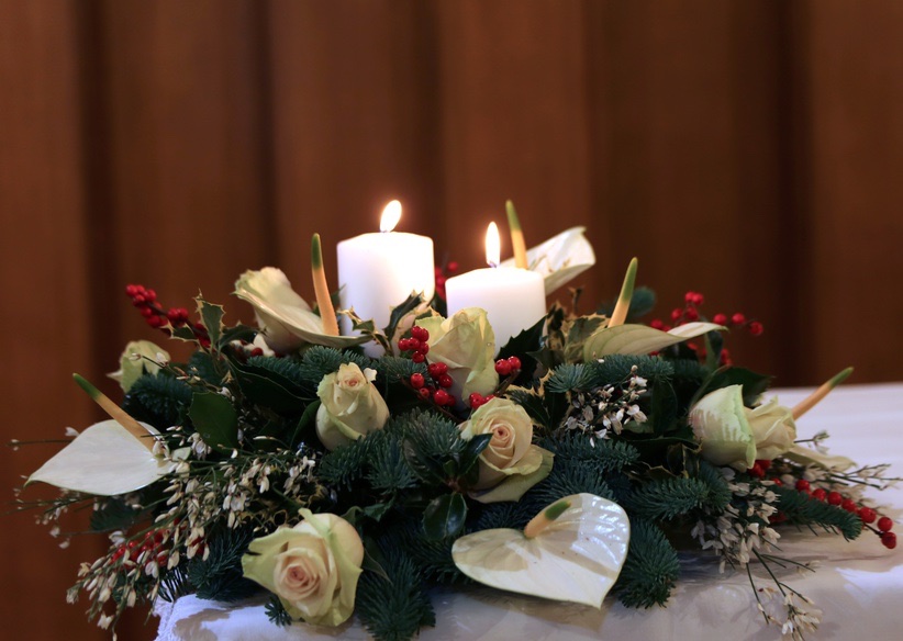 Christmas centerpiece with white roses, white anthurium, greenery and decoration